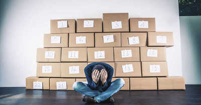 Young Man Sitting with His Head in His Hands with Boxes in the Background, OCD, Obsession, Obsessive Behavior, Obsessive Behaviour, 